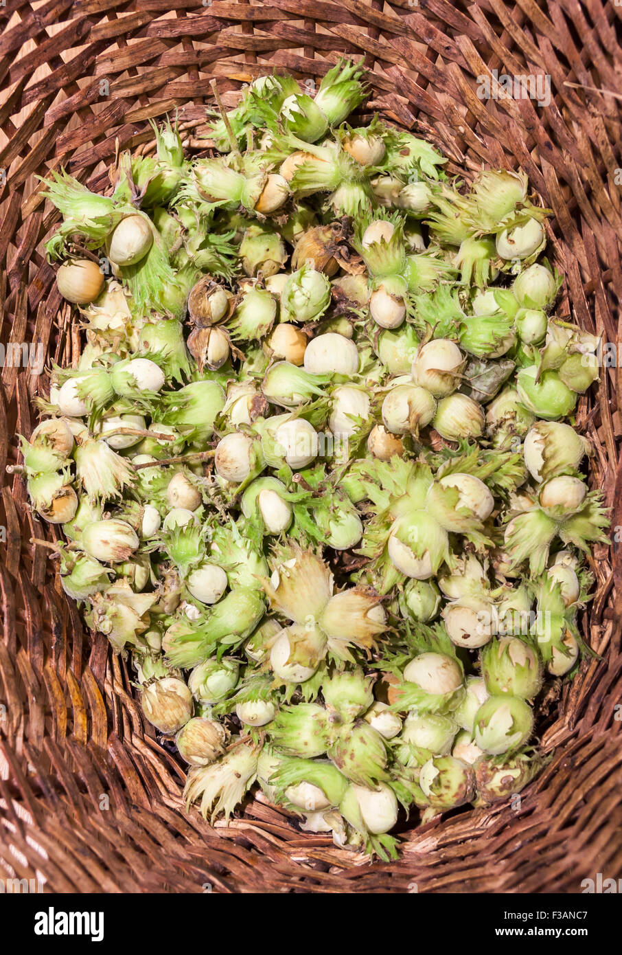 Fresh nuts in brown canework basket Stock Photo