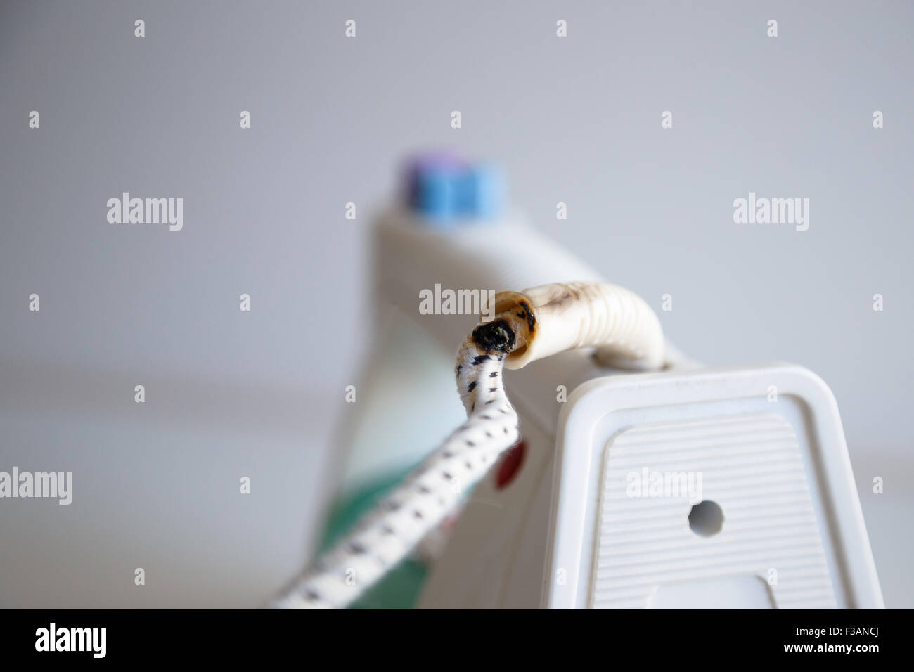 Damage on a lead of an electric iron caused by a short circuit. Stock Photo