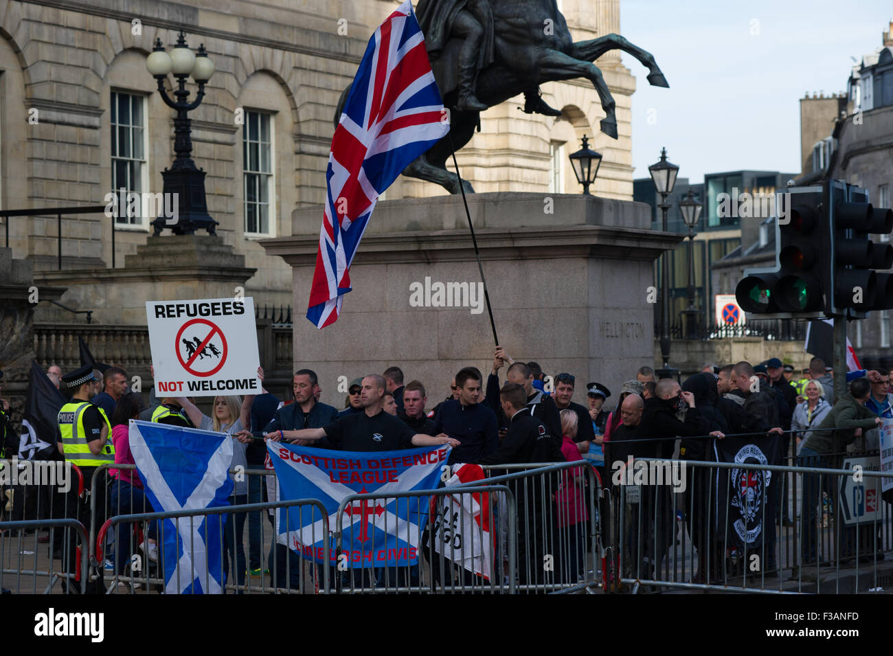 Edinburgh, Scotland 3rd of October 2015. Scottish Defence league held a protest against immigration but were met by a larger counter protest group carrying signs saying 'Nae Nazis'. The SDL protested next to a Duke of Wellington statue where as the other group where held on Princess Street by the police. Credit:  Andrew Steven Graham/Alamy Live News Stock Photo