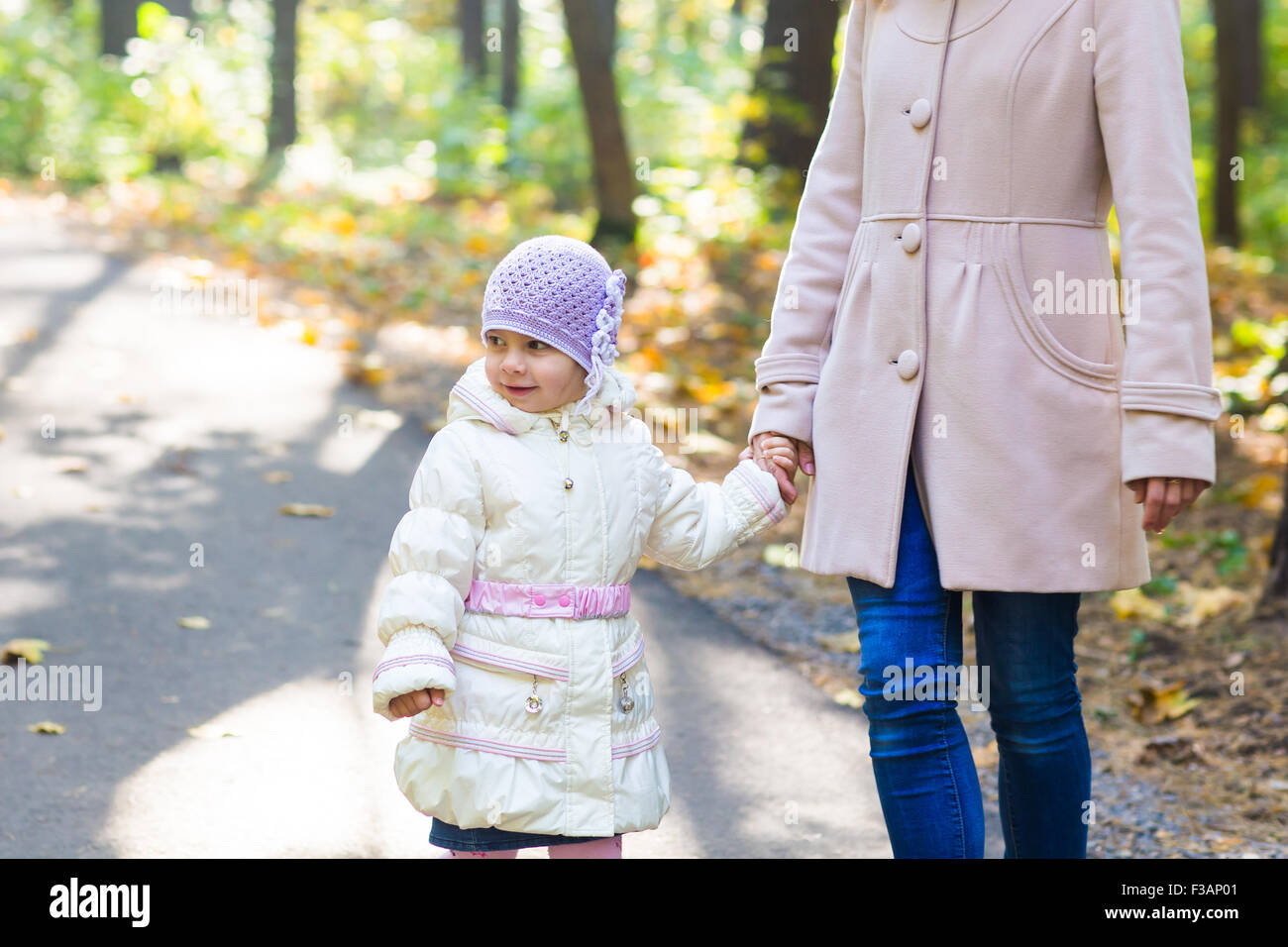 Mother and daughter in an autumn park Stock Photo - Alamy