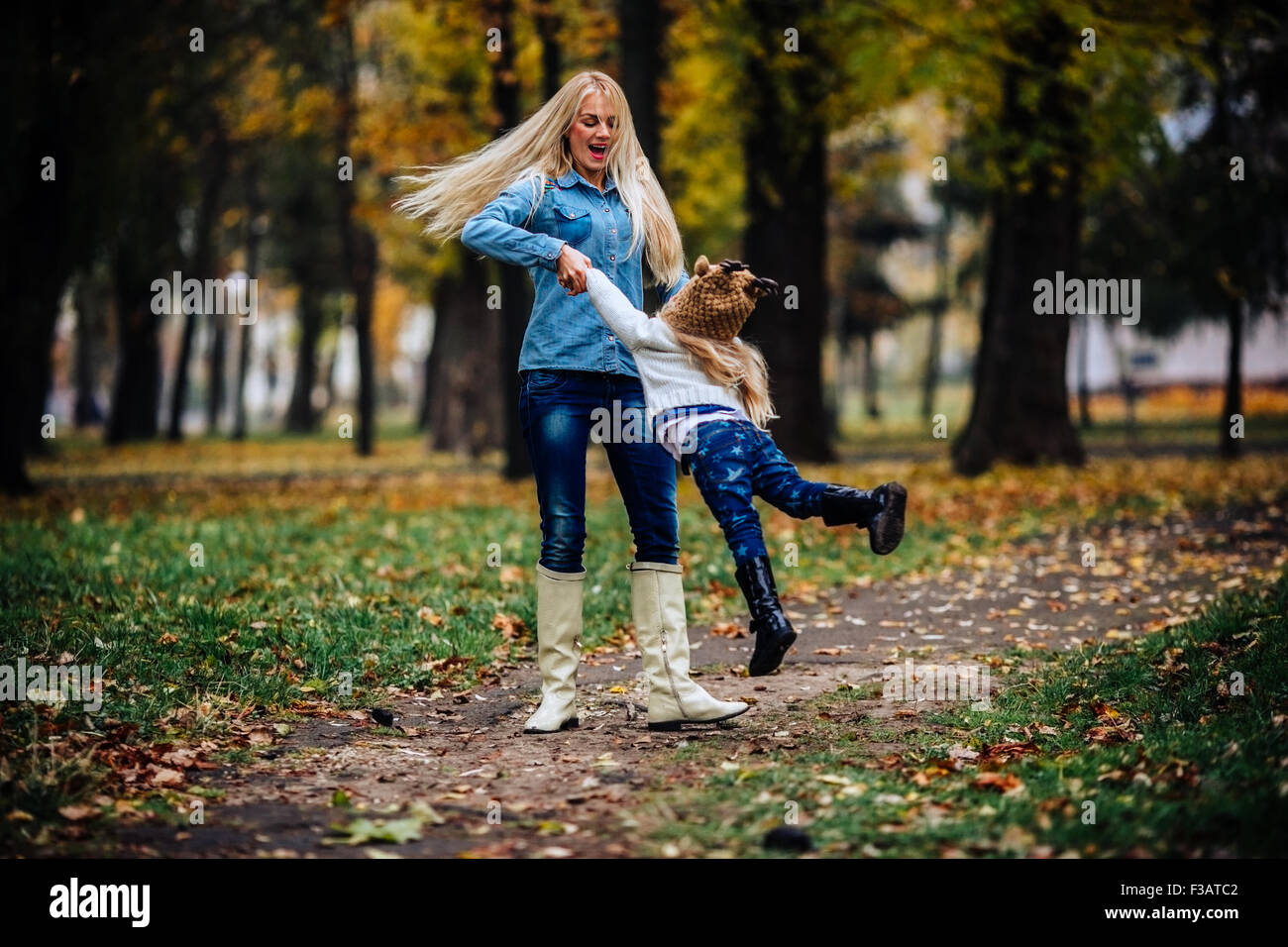 mother and daughter having fun in autumn park Stock Photo - Alamy