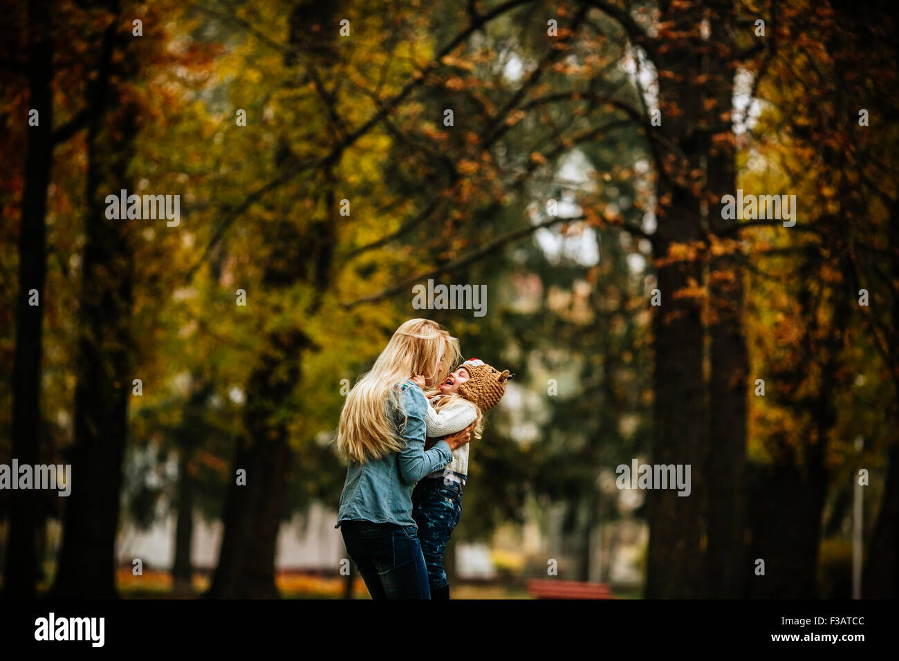 mother and daughter having fun in autumn park Stock Photo - Alamy