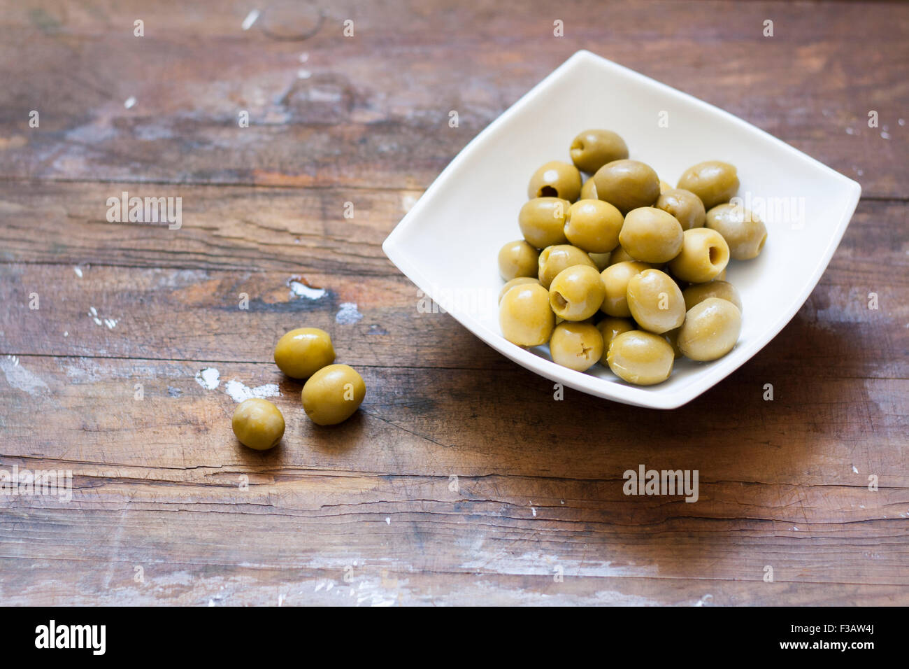 Green olives in marinade Stock Photo
