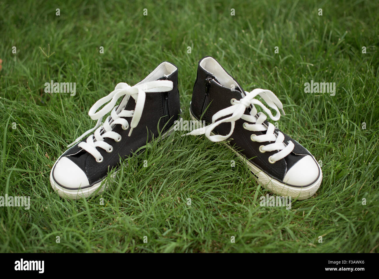 Black sport shoes on a grass sneakers Stock Photo Alamy