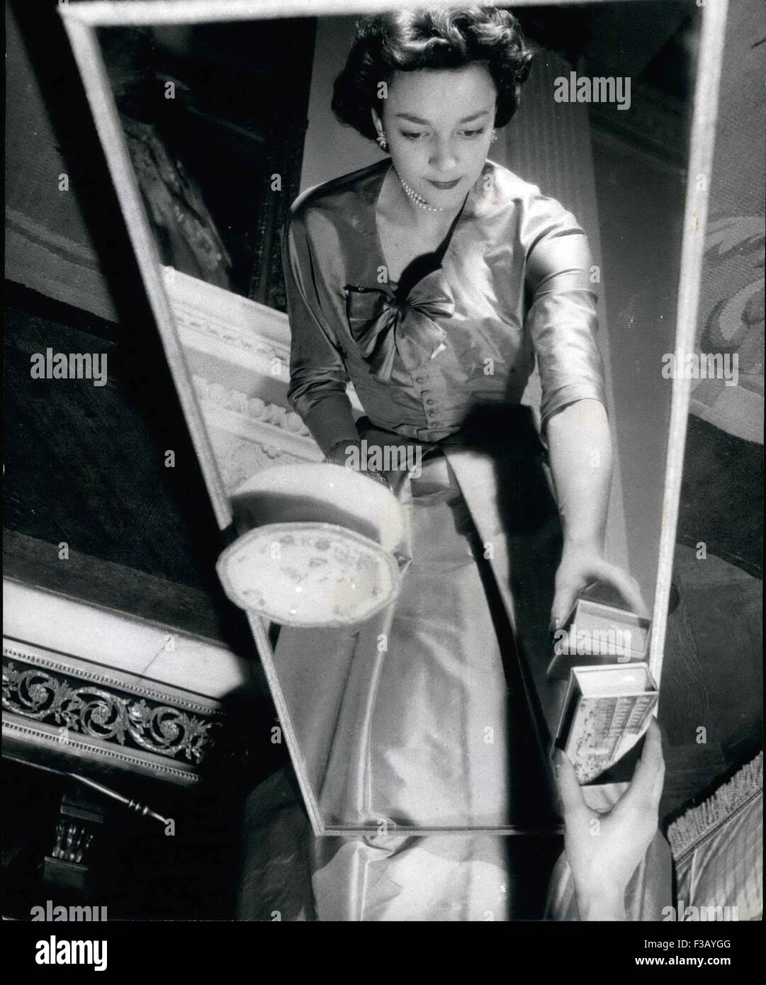 Dec. 19, 1965 - An unusual photograph of Lady Mary Baillie-Hamilton reflected in the mirror top table in the drawing room of her home at Chelsea. She Will Attend The Queen On Coronation Day: Six beautiful girls whose ages range from 17 to 83 have been chosen by the Queen to be her Maids of Honour at the Coronation Service. Queen Victoria set the precedent when she was crowned. Maids of Honour instead of the usual Pages carried her train. The girls are being trained by Mary, Duchess of Devonshire, Mistress of the Robes to the Queen. She is showing them how to manage the Royal purple robe, which Stock Photo