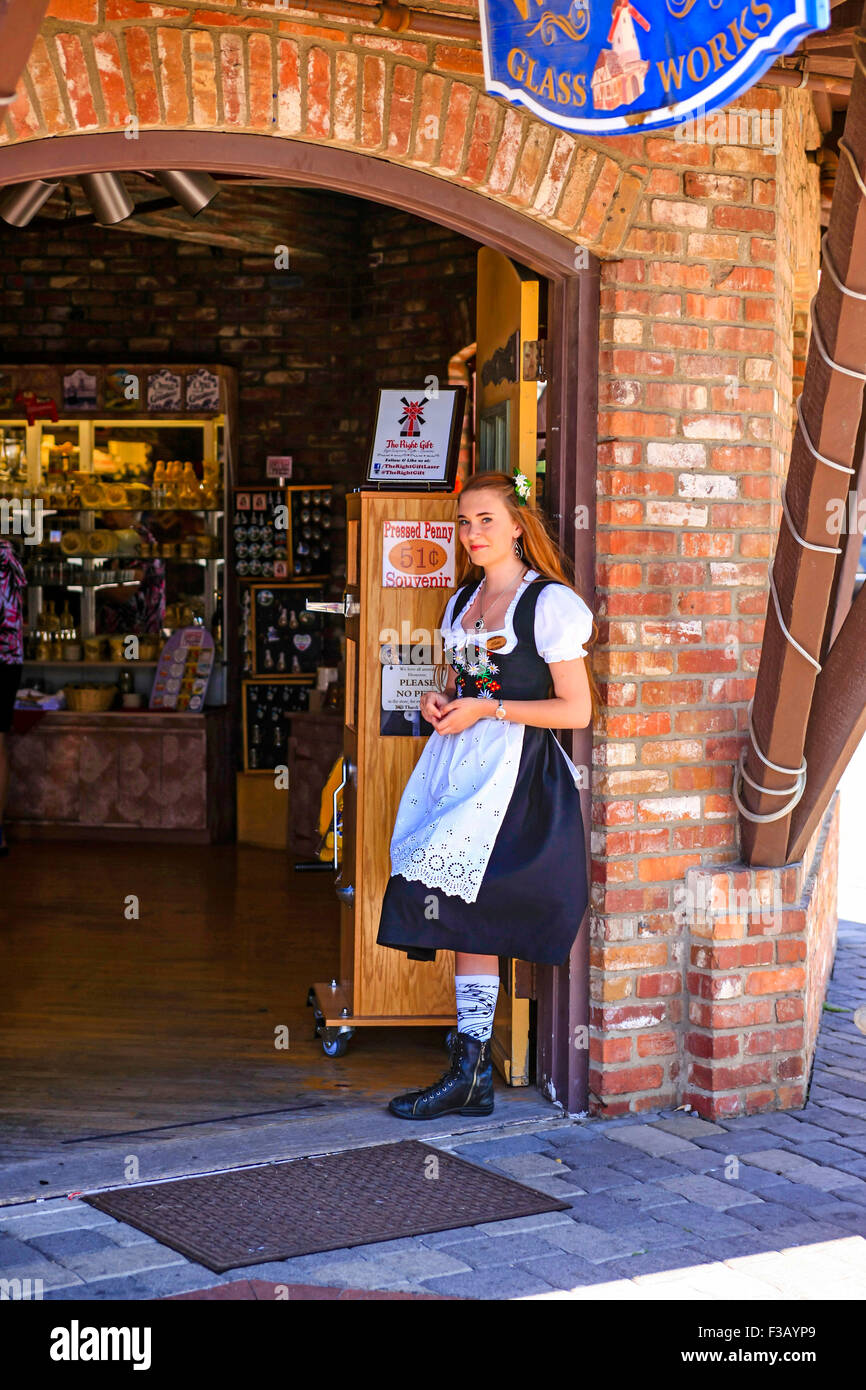 Young woman in a traditional Danish costume stands at the door of a gift  store in the fairytale village of Solvang in the Santa Stock Photo - Alamy