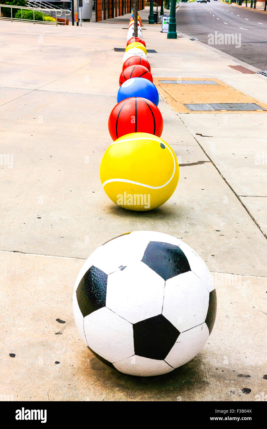 Cement Soccer ball, Tennis ball, Basketball, Pool ball, Baseball artwork seen outside the FedEx Forum building in Memphis TN Stock Photo