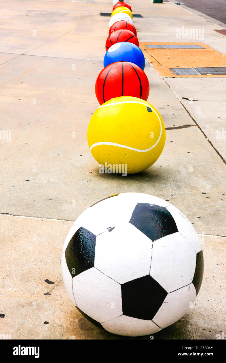 Cement Soccer ball, Tennis ball, Basketball, Pool ball, Baseball artwork seen outside the FedEx Forum building in Memphis TN Stock Photo