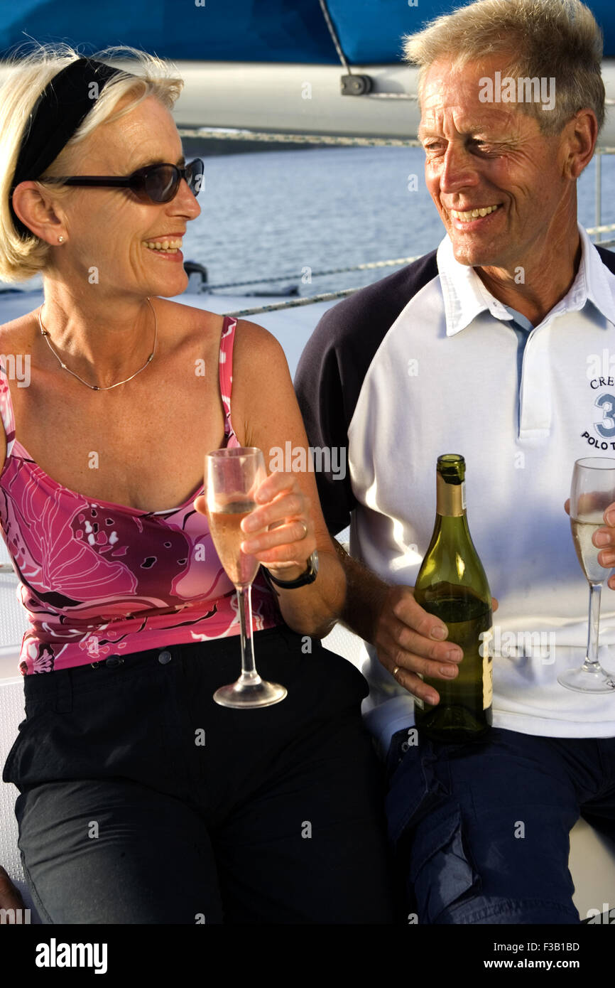 Older couple enjoying an evening drink on board a yacht Stock Photo