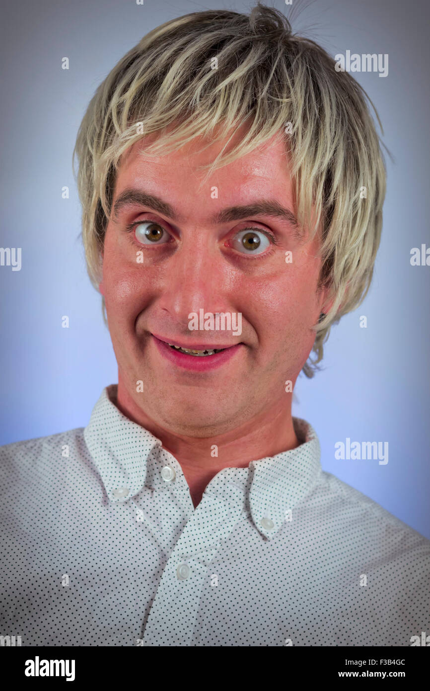 Grinning Silly Man With Blonde Hair And Wide Eyes Stock Photo