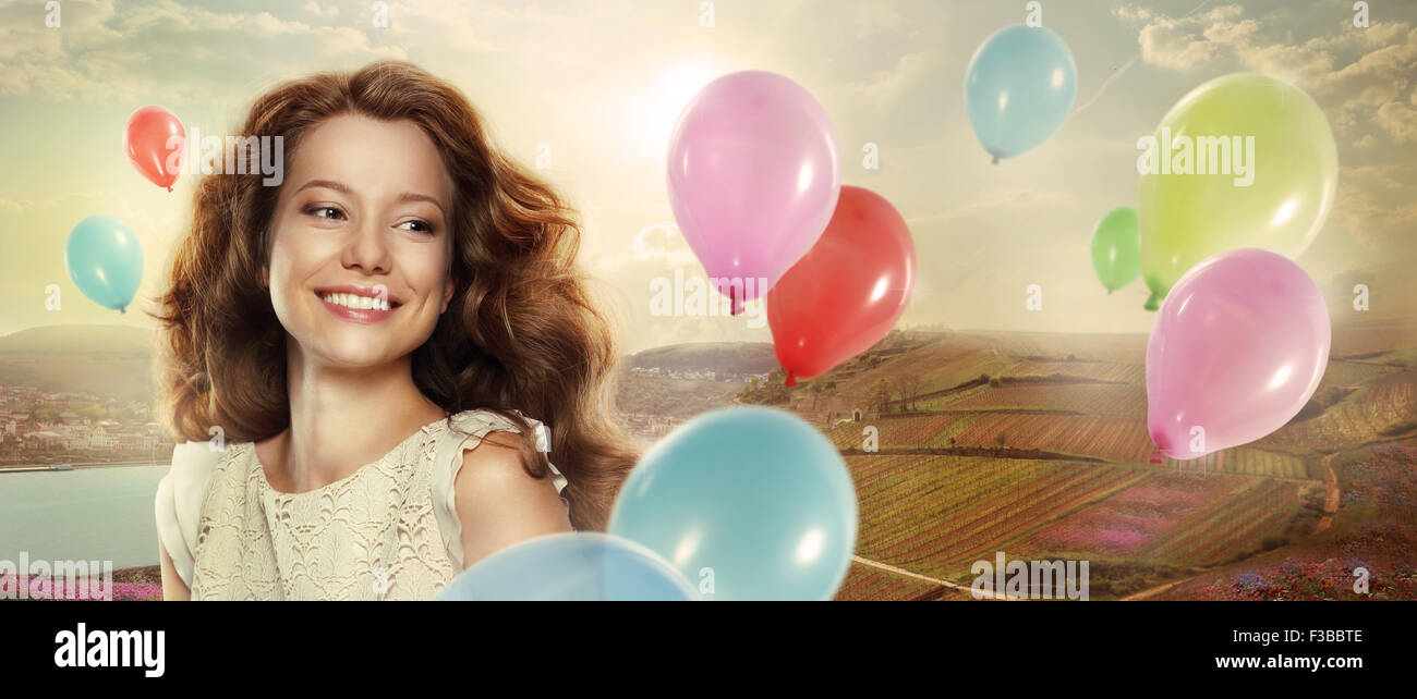 Holiday. Happy Woman with Colorful Air Balloons Stock Photo