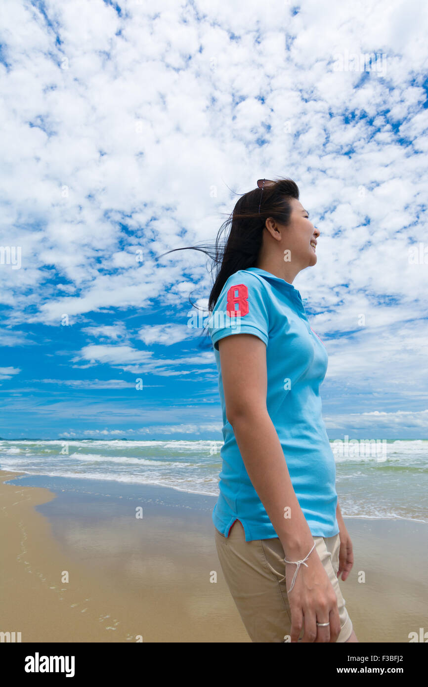 Happy young woman on the beach Stock Photo - Alamy
