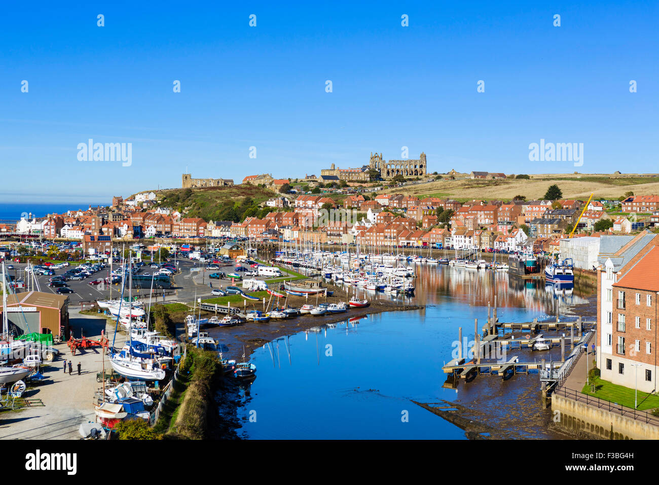 View over the fishing port of Whitby with the Abbey on the hilltop, North Yorkshire, England, UK Stock Photo