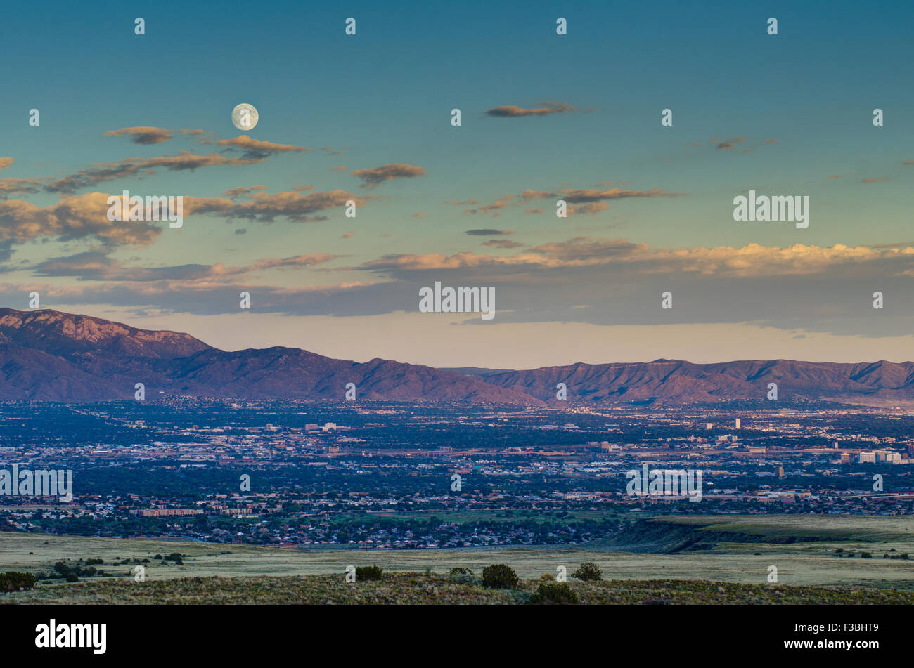 Full moon rise over Albuquerque and the Sandia mountains, New Mexico, USA. Stock Photo