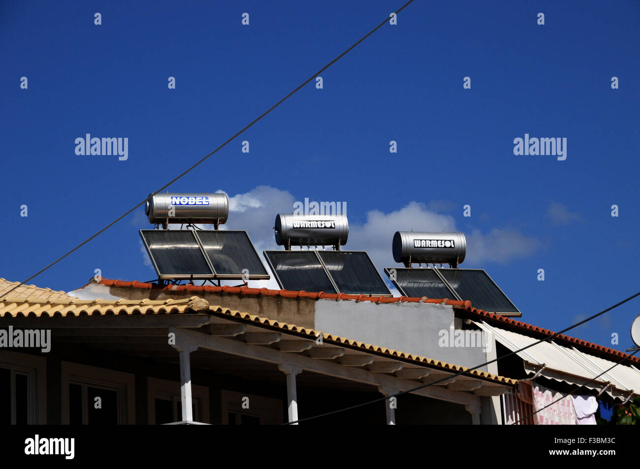 Solar water heaters on a roof top in the small Greek village of Giolova in the Peloponnese. Stock Photo