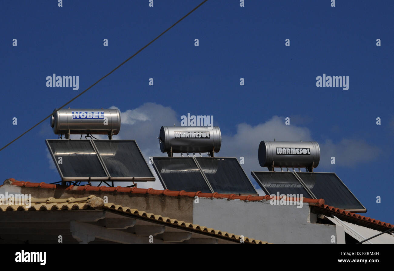 Solar water heaters on a roof top in the small Greek village of Giolova in the Peloponnese. Stock Photo