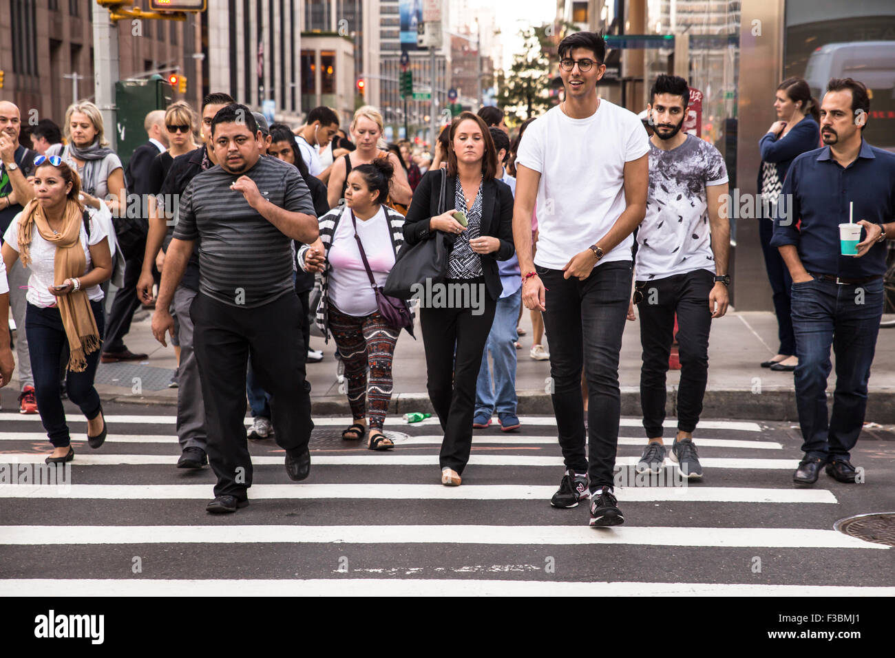 NEW YORK CITY - SEPTEMBER 14, 2015: Pictured here is a crosswalk in midtown Manhattan with a diversity of pedestrians crossing Stock Photo