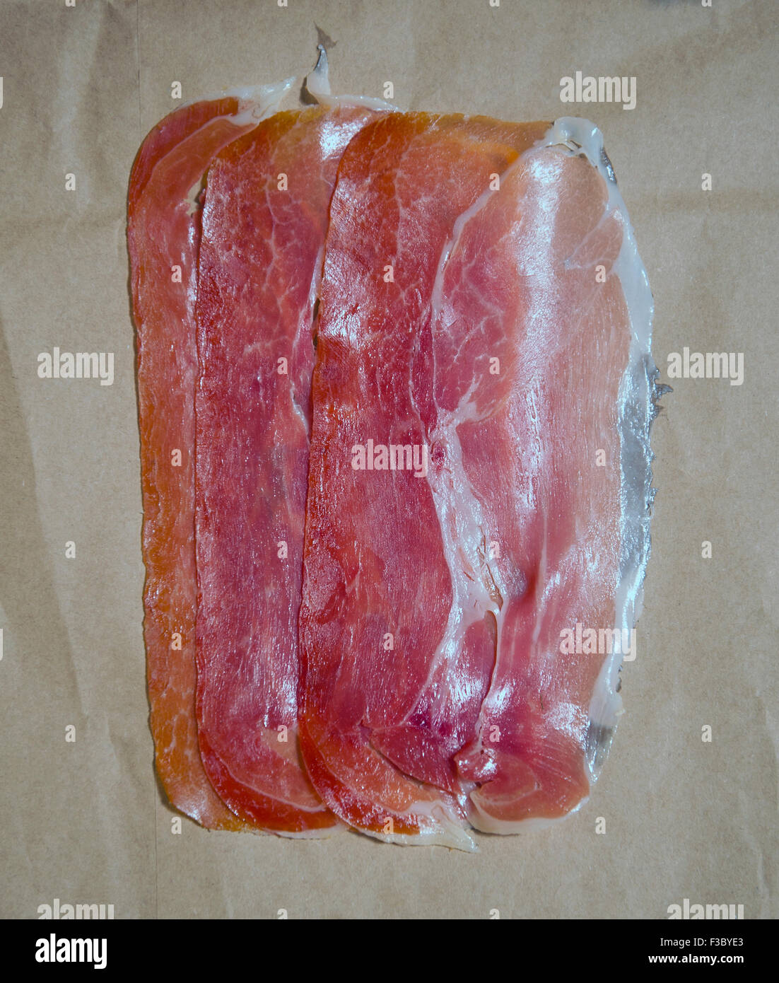 Overhead view of slices of cured ham Stock Photo