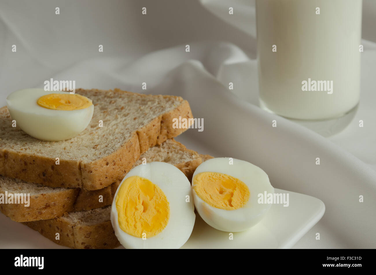 Easy Breakfast with Whole Grain Bread, Boiled Egg and Milk Stock Photo
