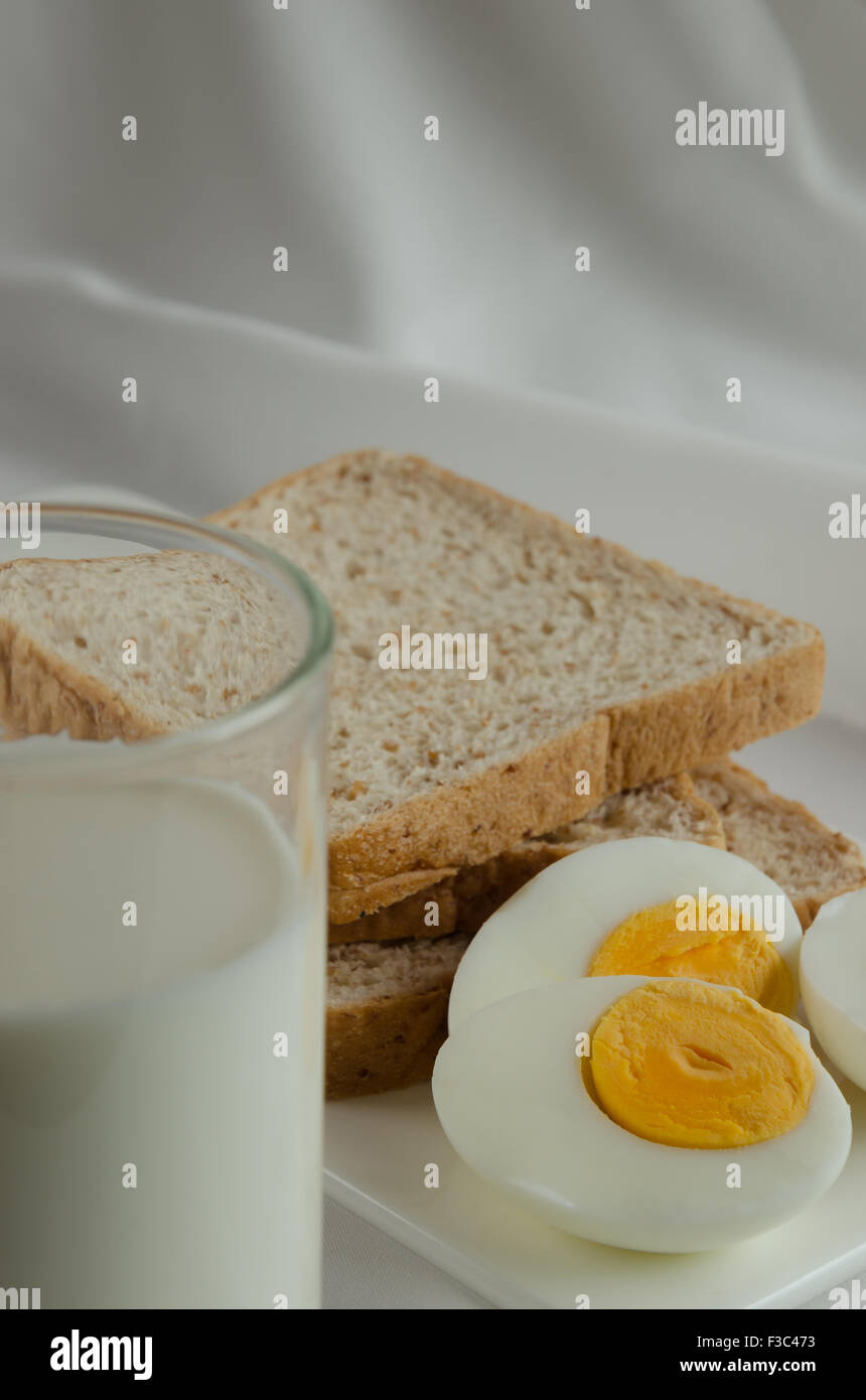 Easy Breakfast with Whole Grain Bread, Boiled Egg and Milk Stock Photo