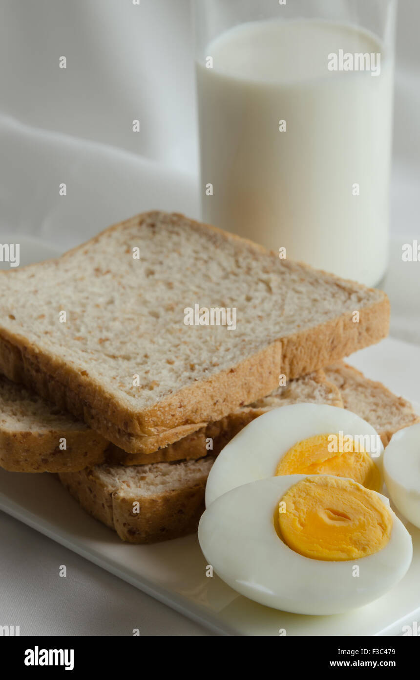 Easy Breakfast with Whole Grain Bread, Boiled Egg and Milk Stock Photo