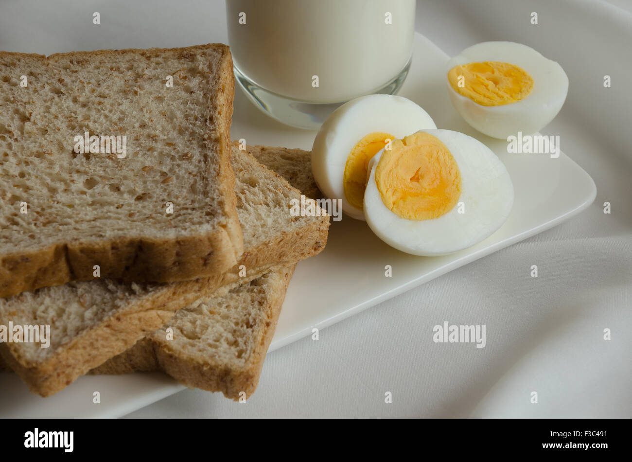 Easy Breakfast with Whole Grain Bread, Boiled Egg and Milk Stock Photo