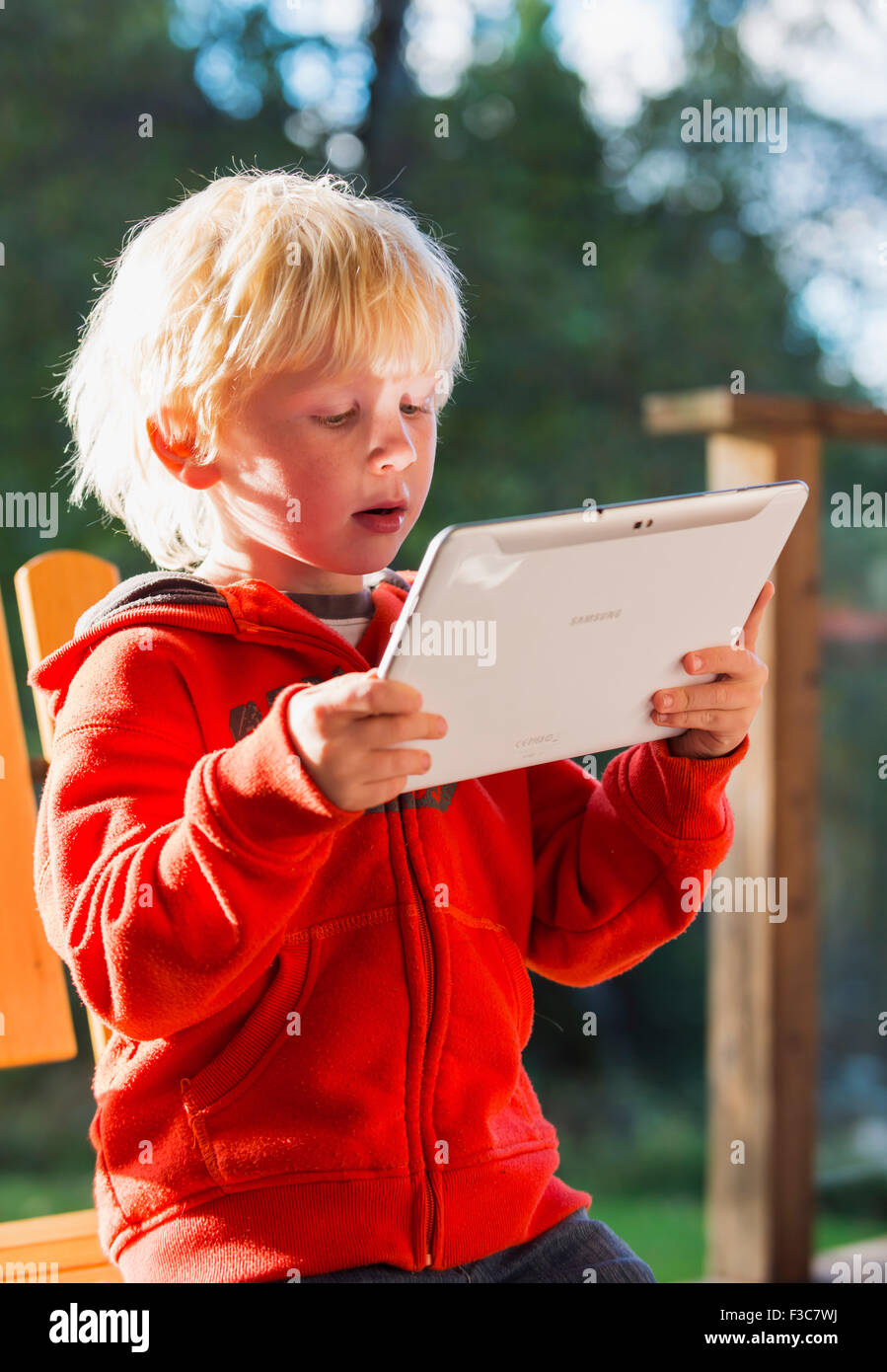 Young boy with Ipad Stock Photo - Alamy