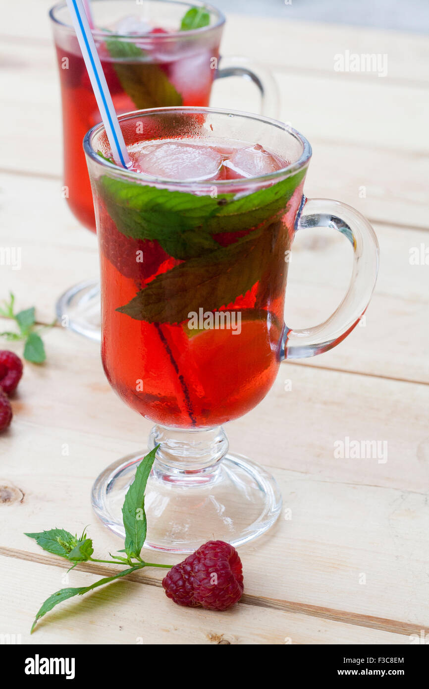 Fresh Raspberry Drink Raspberries fresh drinks with ice and mint on wooden table, selective ...