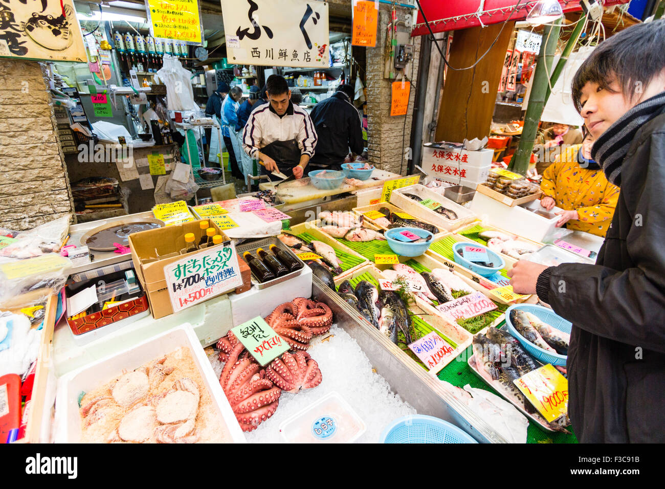 Japan, Osaka, Kuromon Ichiba Market.Fish monger stall and shop with