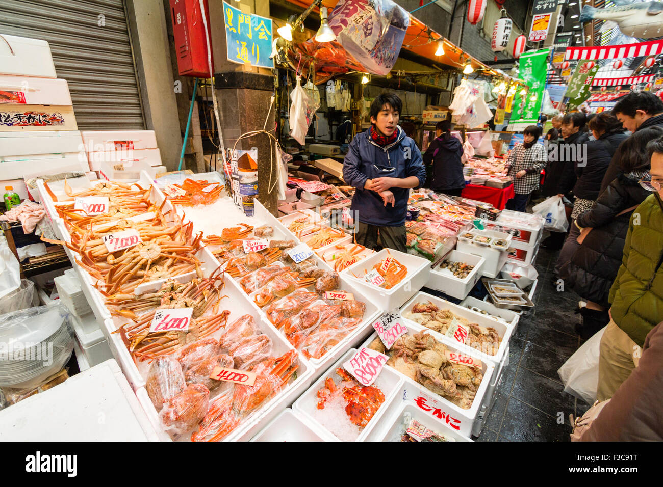 Kuromon market in Osaka. Fish stall selling freshly caught fish to
