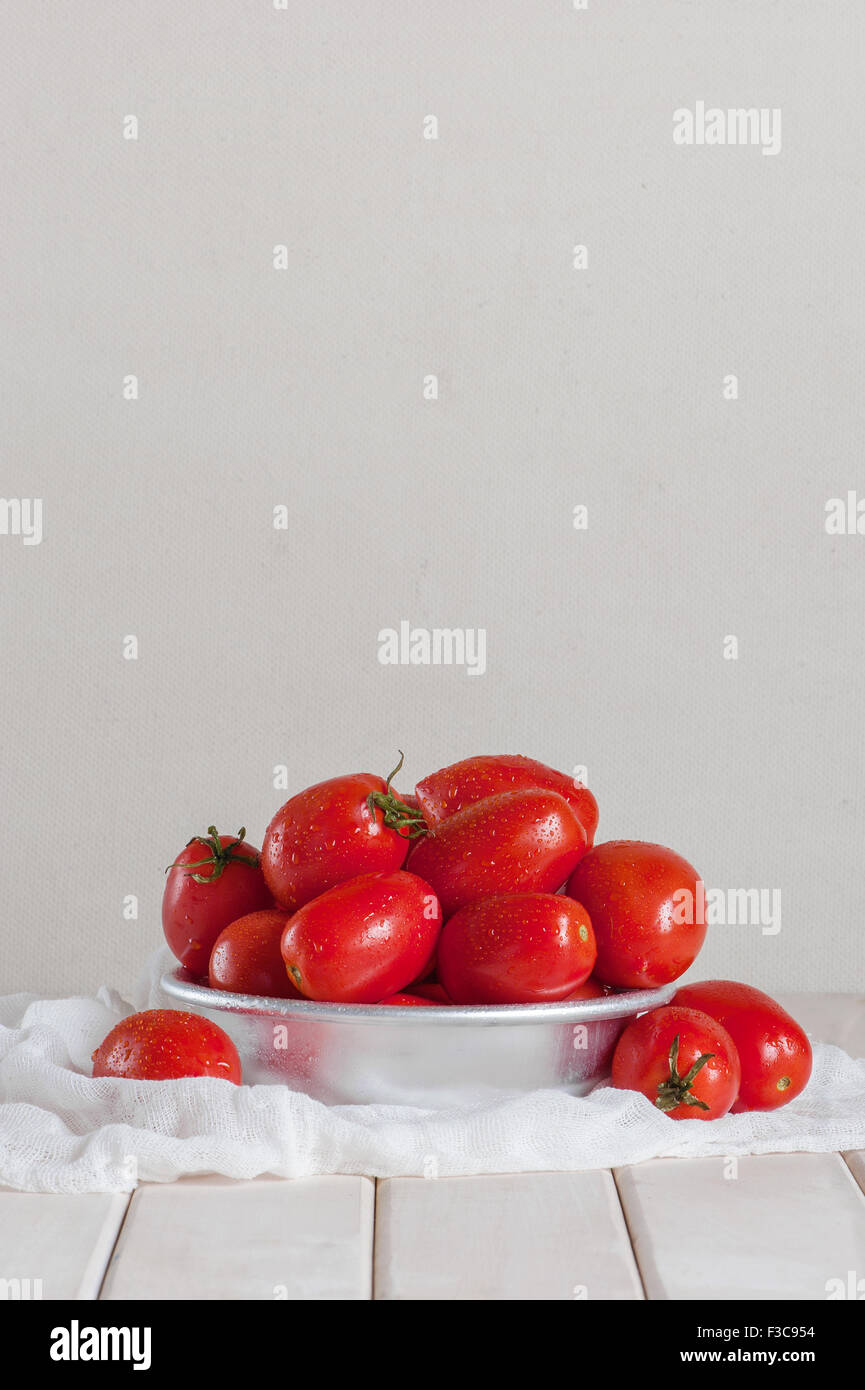 Ripe tomatoes on the white wooden table Stock Photo - Alamy