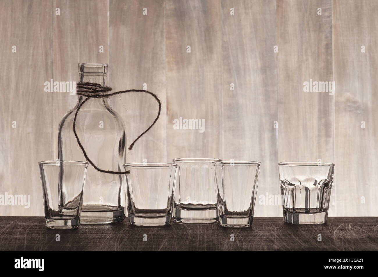 Empty bottle and shots on the wooden bar counter Stock Photo Alamy