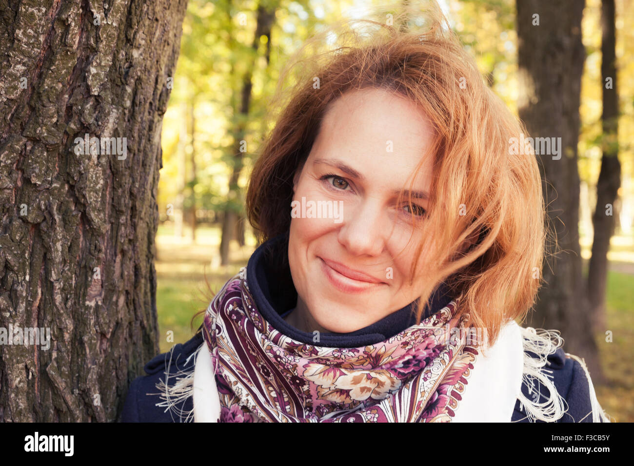 Outdoor portrait of smiling Young Caucasian woman in traditional Russian Pavloposadskie neck scarf Stock Photo
