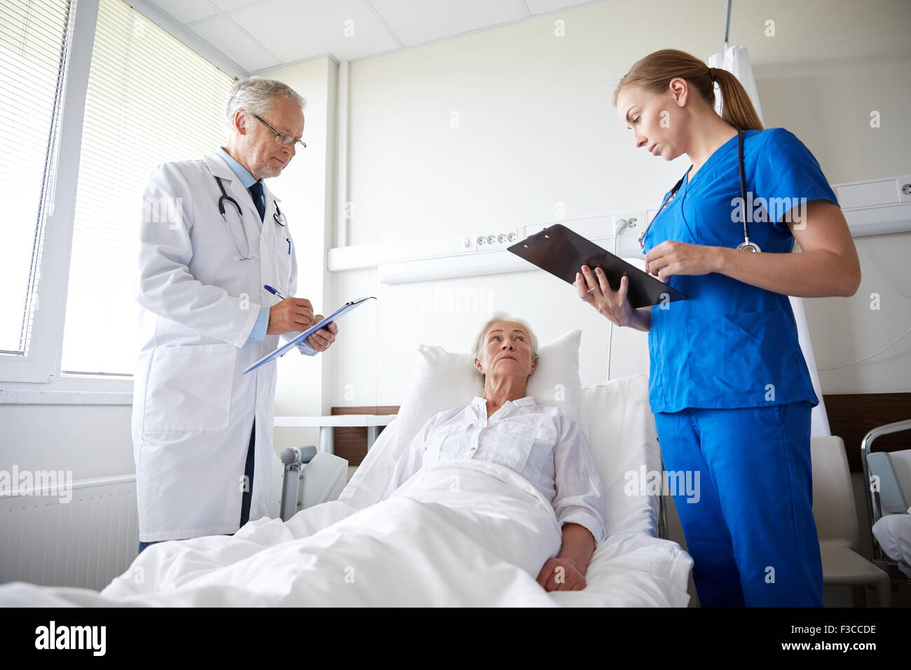 doctor and nurse visiting senior woman at hospital Stock Photo - Alamy