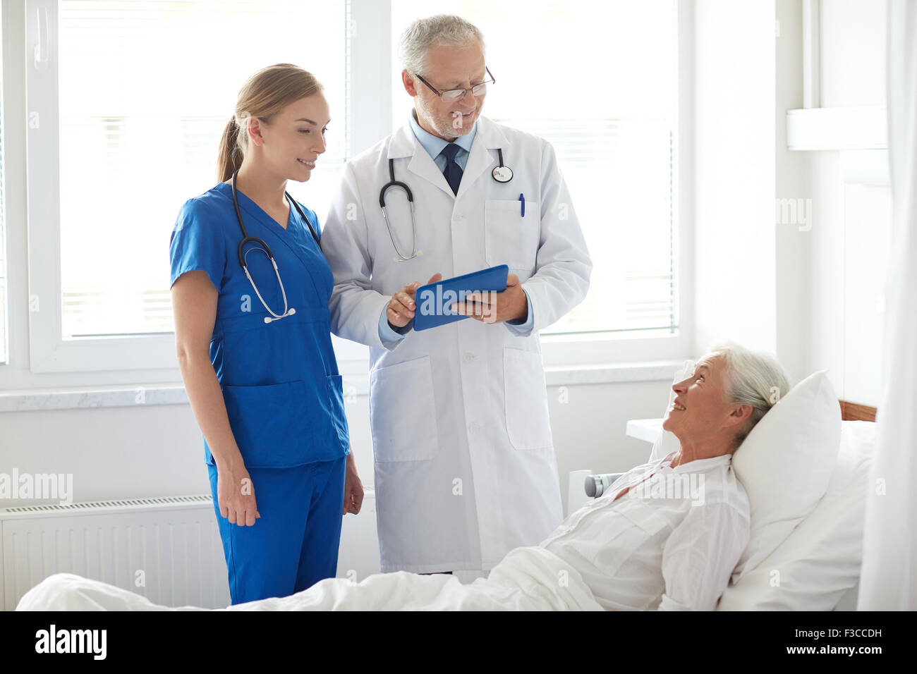 doctor and nurse visiting senior woman at hospital Stock Photo - Alamy