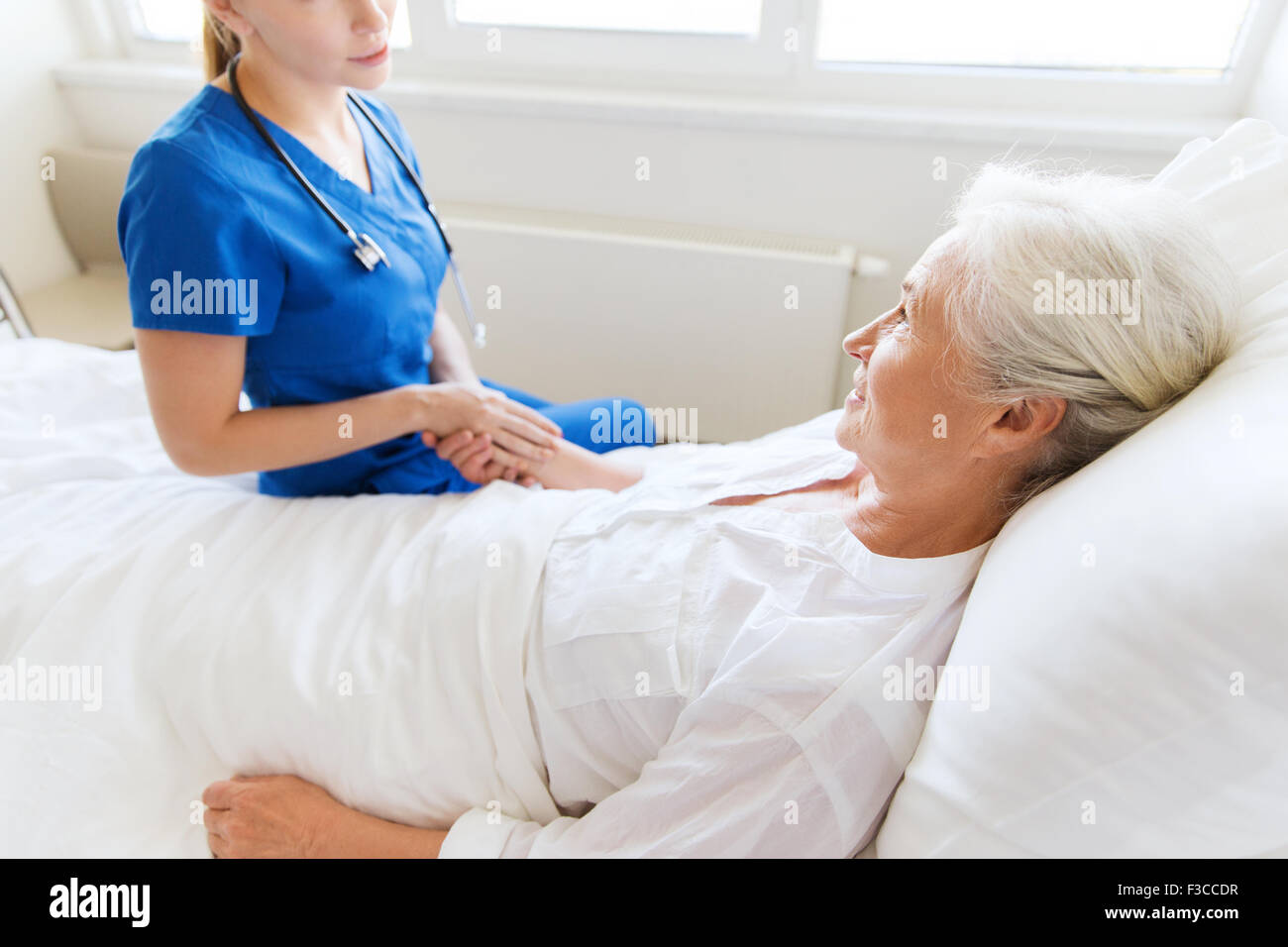 doctor or nurse visiting senior woman at hospital Stock Photo - Alamy