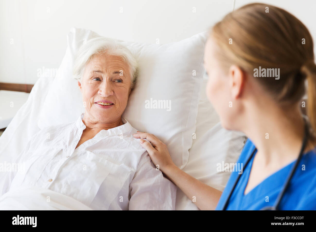 doctor or nurse visiting senior woman at hospital Stock Photo - Alamy