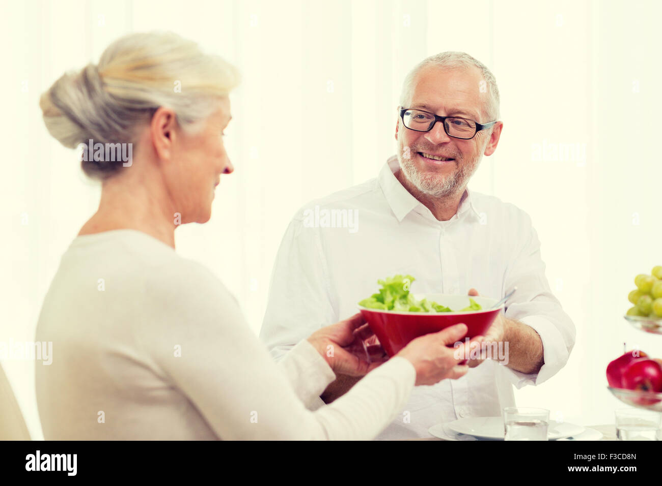 smiling senior couple having dinner at home Stock Photo