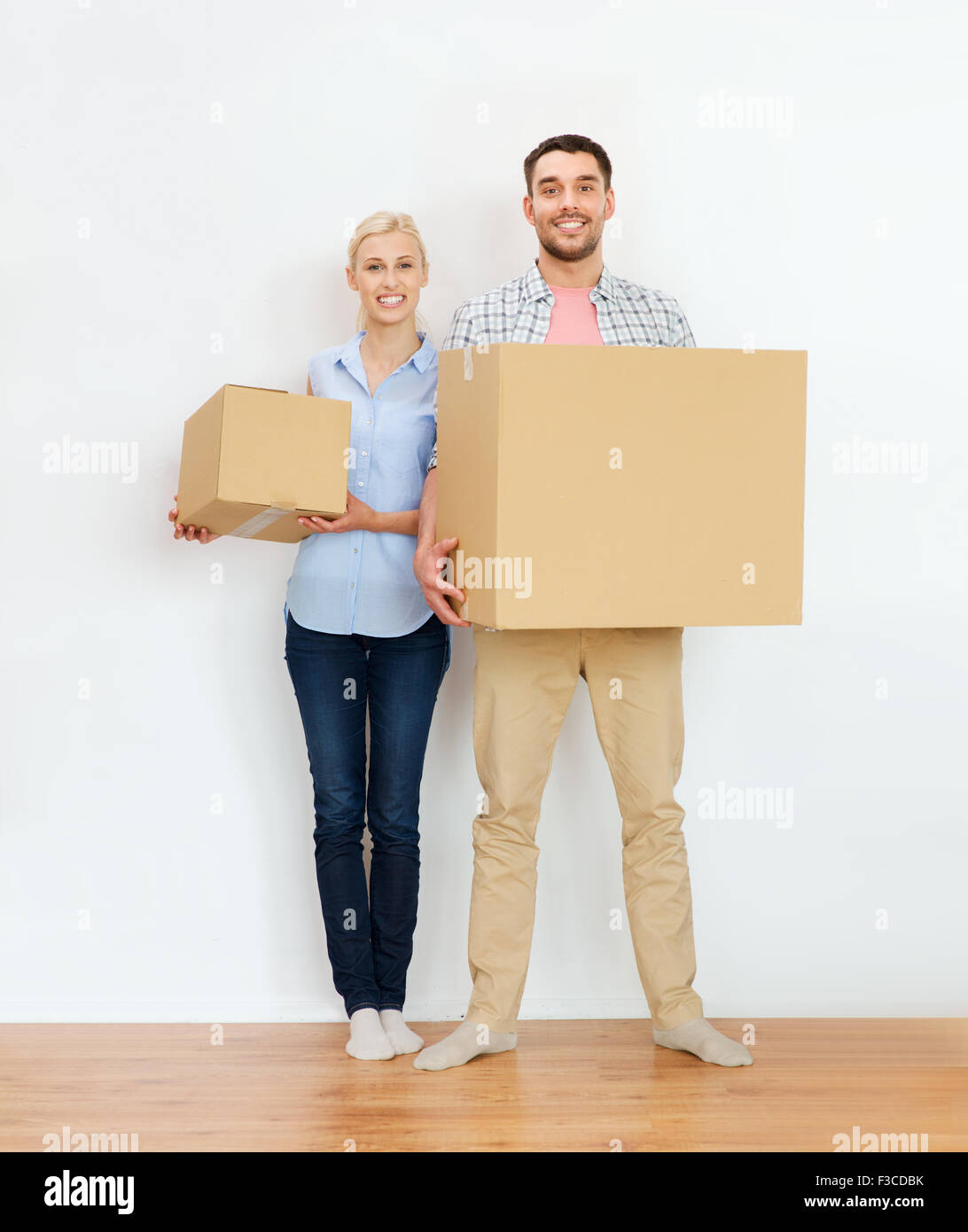 couple with cardboard boxes moving to new home Stock Photo - Alamy