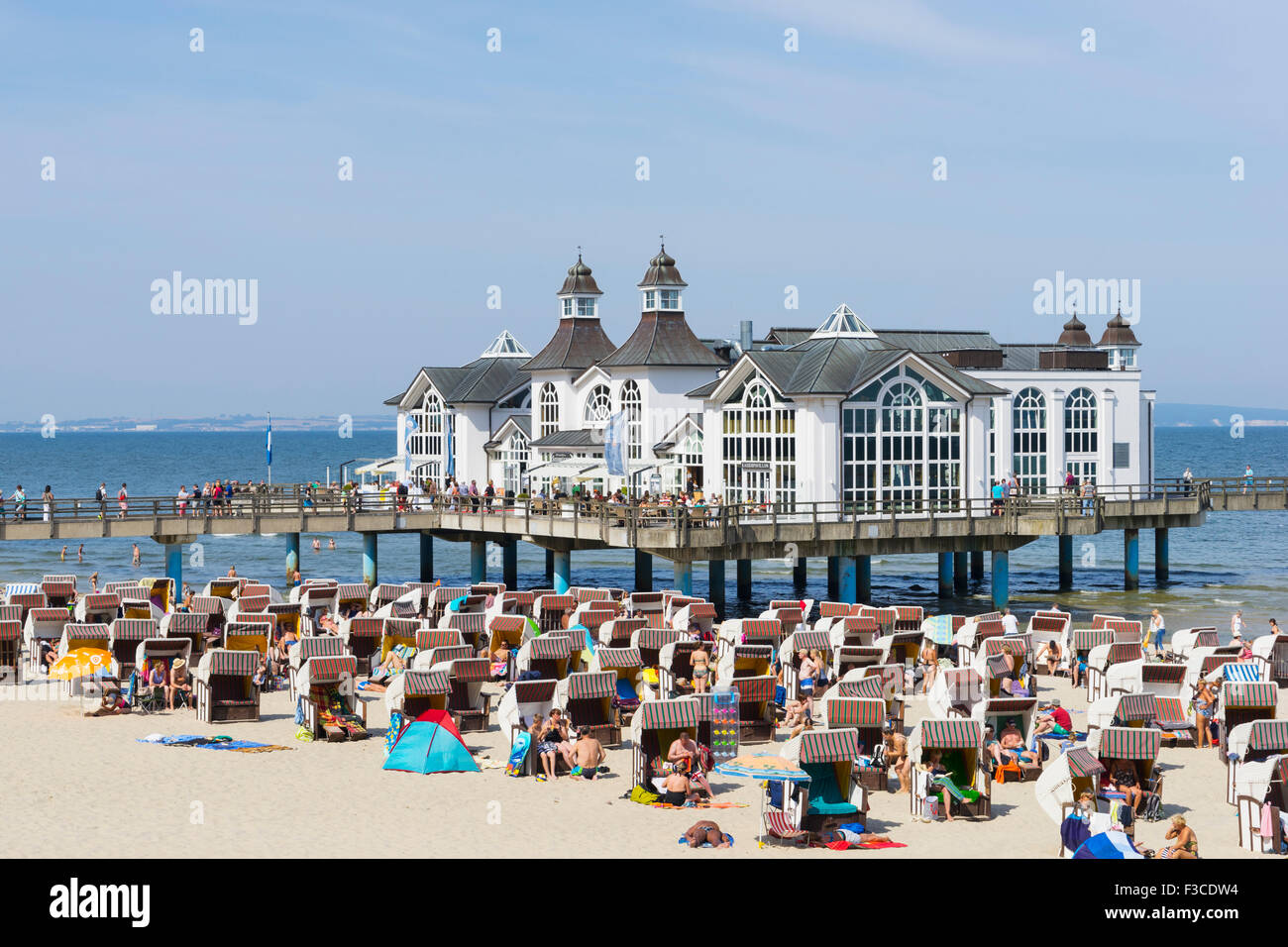 View of Pier and many traditional Strandkorb beach chairs on beach at Sellin resort on  Rugen Island , Germany Stock Photo