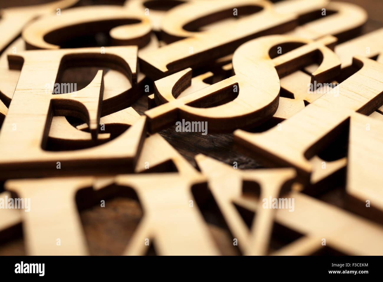 Wooden alphabet letters on old wooden surface with space for your own text. Stock Photo