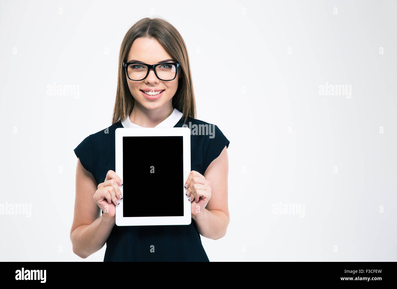 Portrait of a smiling woman showing blank tablet computer screen ...