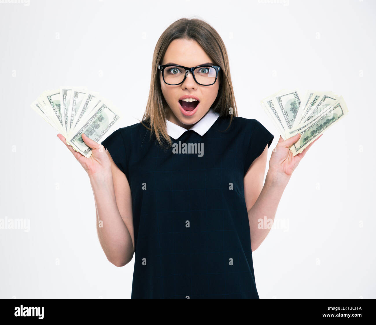 Portrait of a cheerful woman holding dollar bills isolated on a white ...