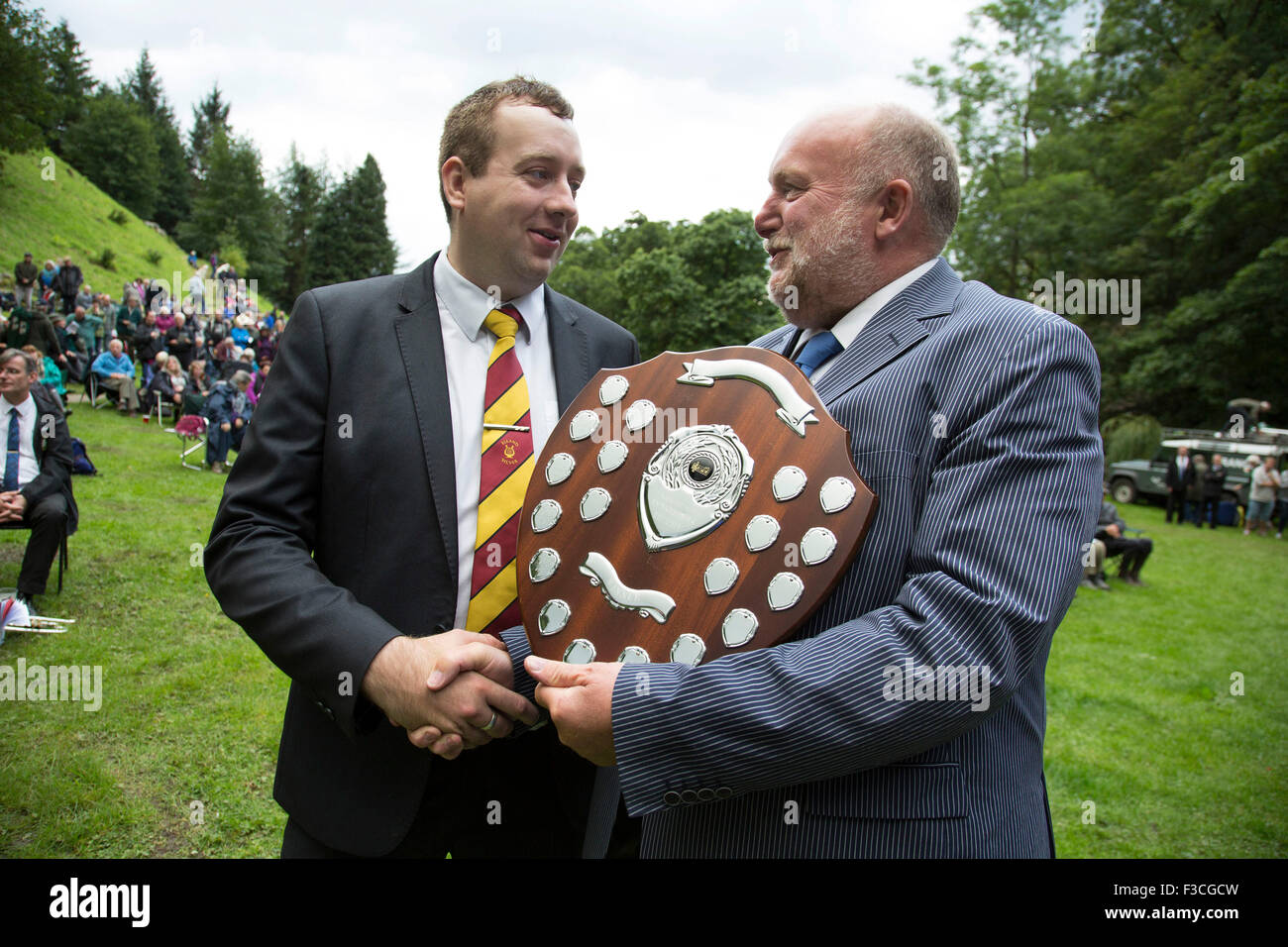 The Hardraw Scaur Brass Band Festival. Winner of the 2015 contest, Elland band, with their leader Daniel Brooks accepting the trophy. Organised by the Yorkshire and Humberside Brass Band Association, the competition is Britain's second oldest outdoor contest and takes place annually in Hardraw Scar in Wensleydale, North Yorkshire, England, UK. The area, a natural amphitheatre, attracts bands from all over the North of England and is a popular event amongst players and audiences alike. Stock Photo