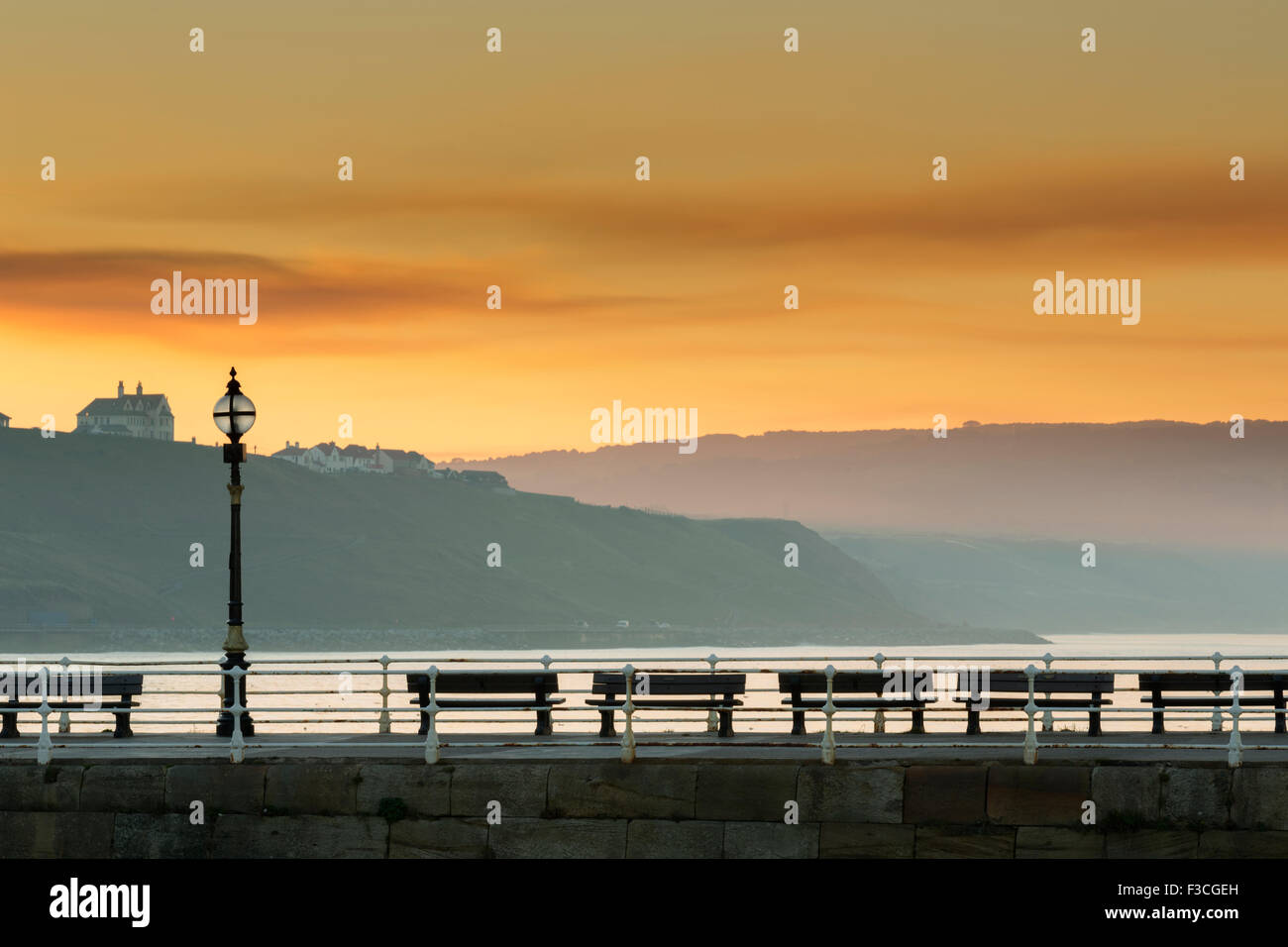 Sunset afterglow over the west pier at Whitby, North Yorkshire coast, October 2015 Stock Photo