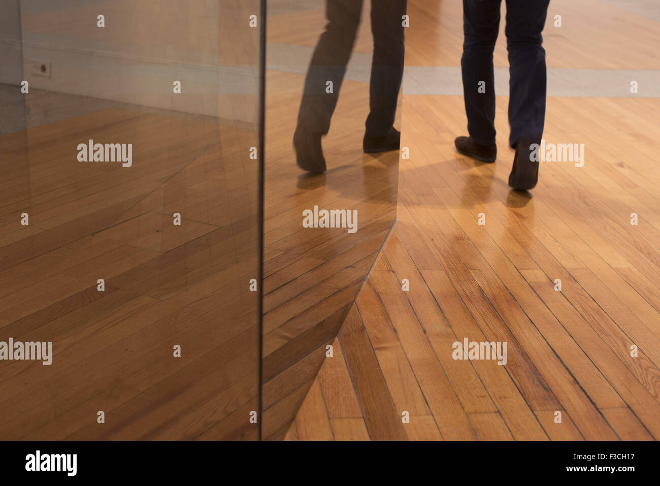Glass walls rising from hardwood floor Stock Photo - Alamy