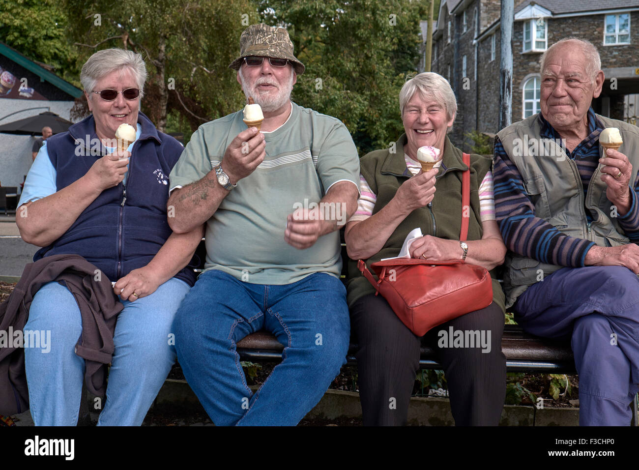 Eating ice cream. Senior people enjoying an ice cream on a days outing. Cumbria England UK Stock Photo