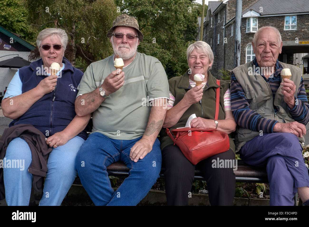 Eating ice cream. Senior people enjoying an ice cream on a days outing. Cumbria England UK Stock Photo