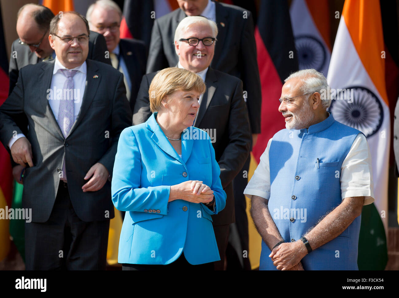 New Delhi, India. 05th Oct, 2015. New Dehli, India. 05th Oct, 2015. German chancellor Angela Merkel and Indian Prime Minister Narendra Modi speak as they pose on the stairs to the Hyderabad House for a group picture after the third Indian-German intergovernmental consultations in New Dehli, India, 05 October 2015. German Foreign Minister Steinmeier stands behind Merkel. Modi are scheduled to lead the third inter-governmental consulta Credit:  dpa/Alamy Live News Stock Photo