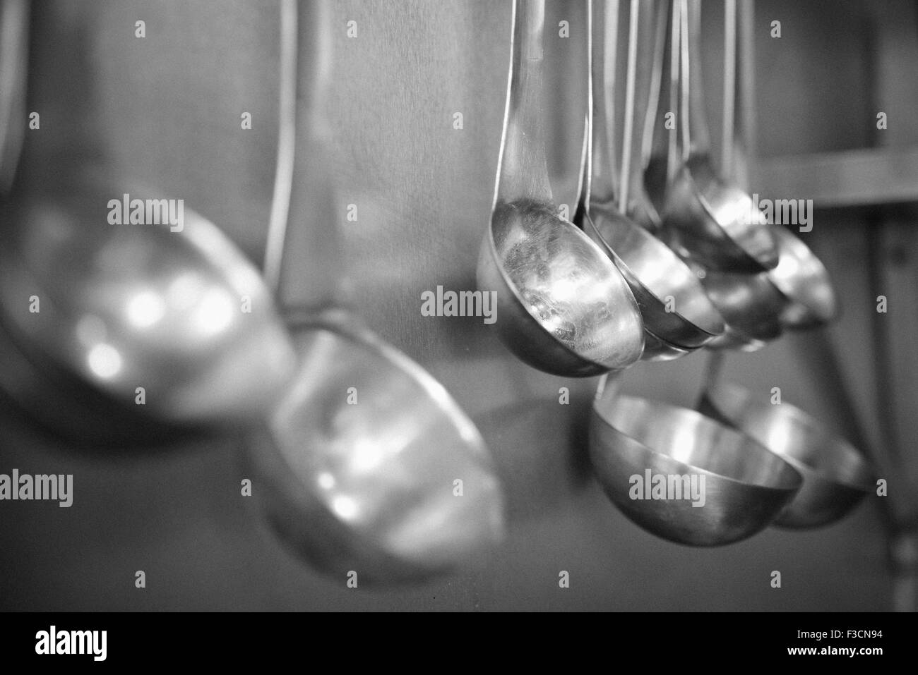 Ladles hanging in row Stock Photo